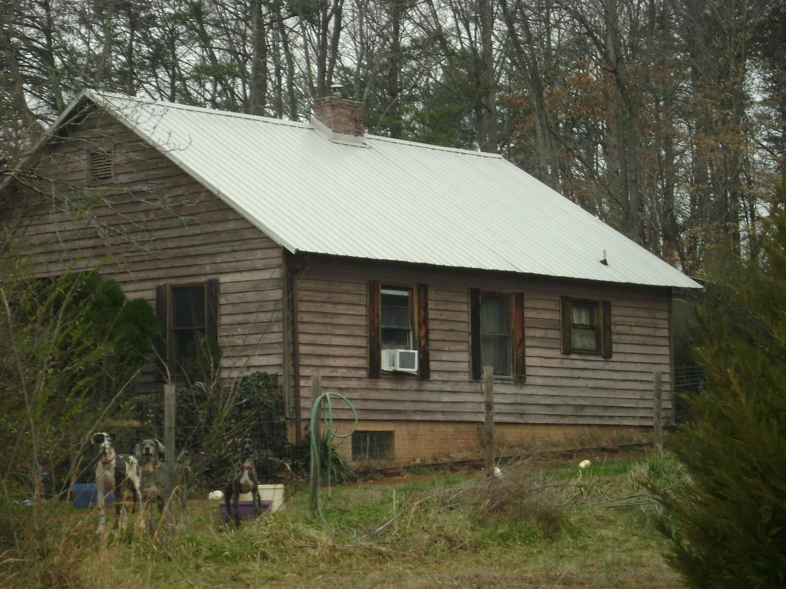 White metal roof on an old wood sided farmhouse, from a Metal Roof Installation job in Knierim